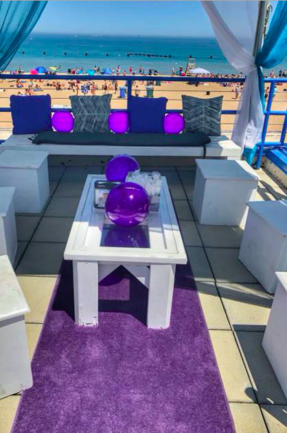 A purple aisle runner at the beach?